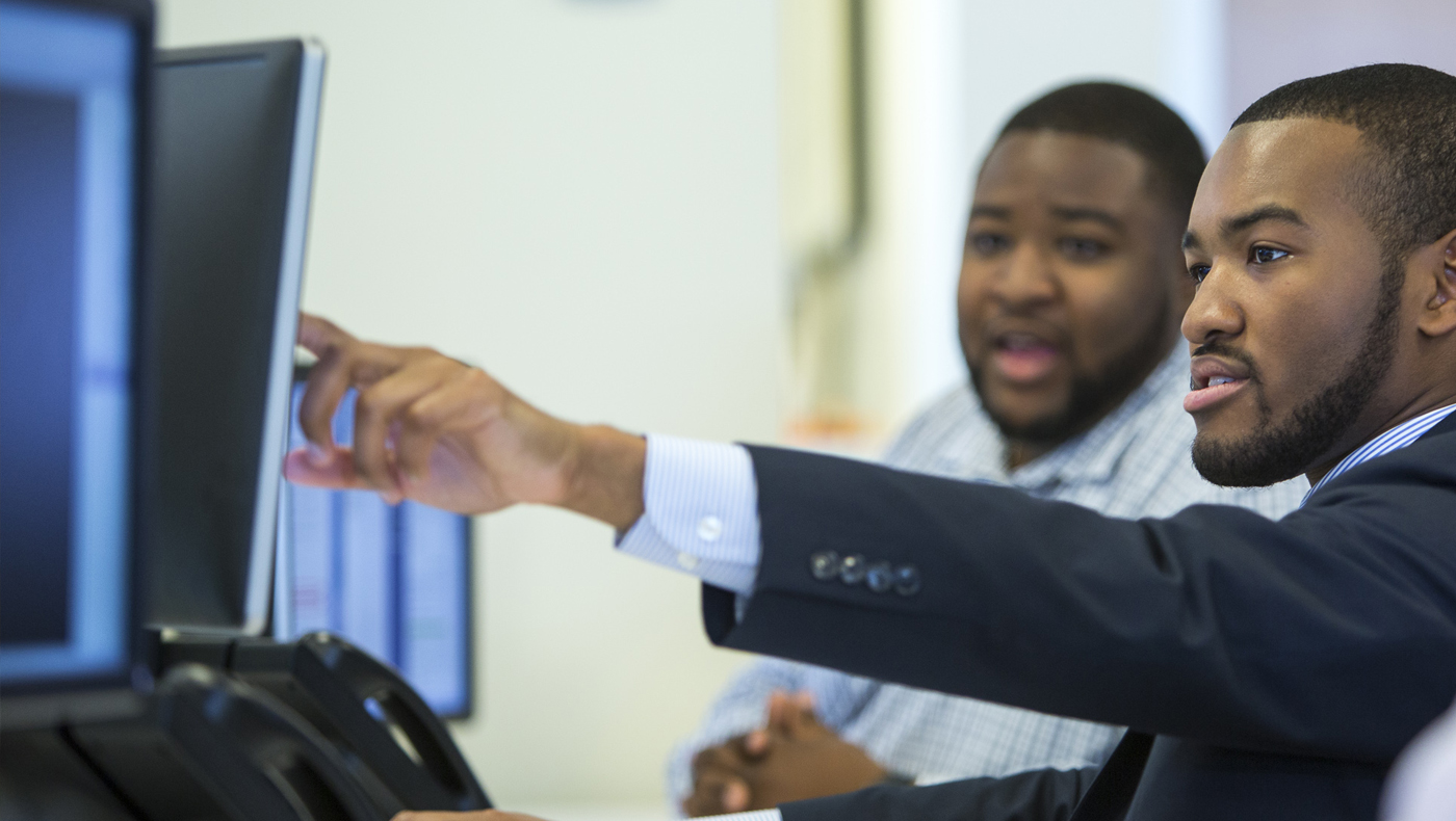 Two accounting & MIS students working together at a computer.