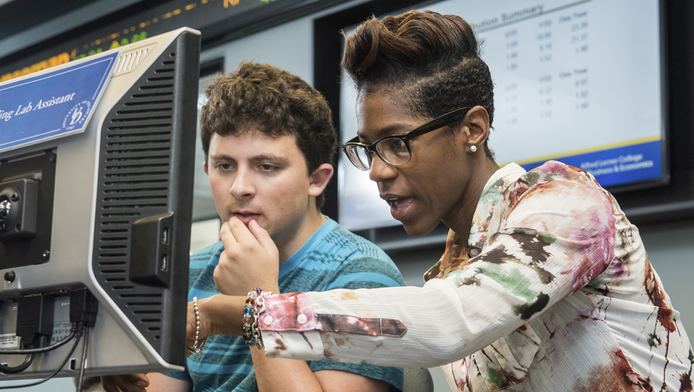 Students working in the Michael and Rosann Geltzeiler Trading Center.