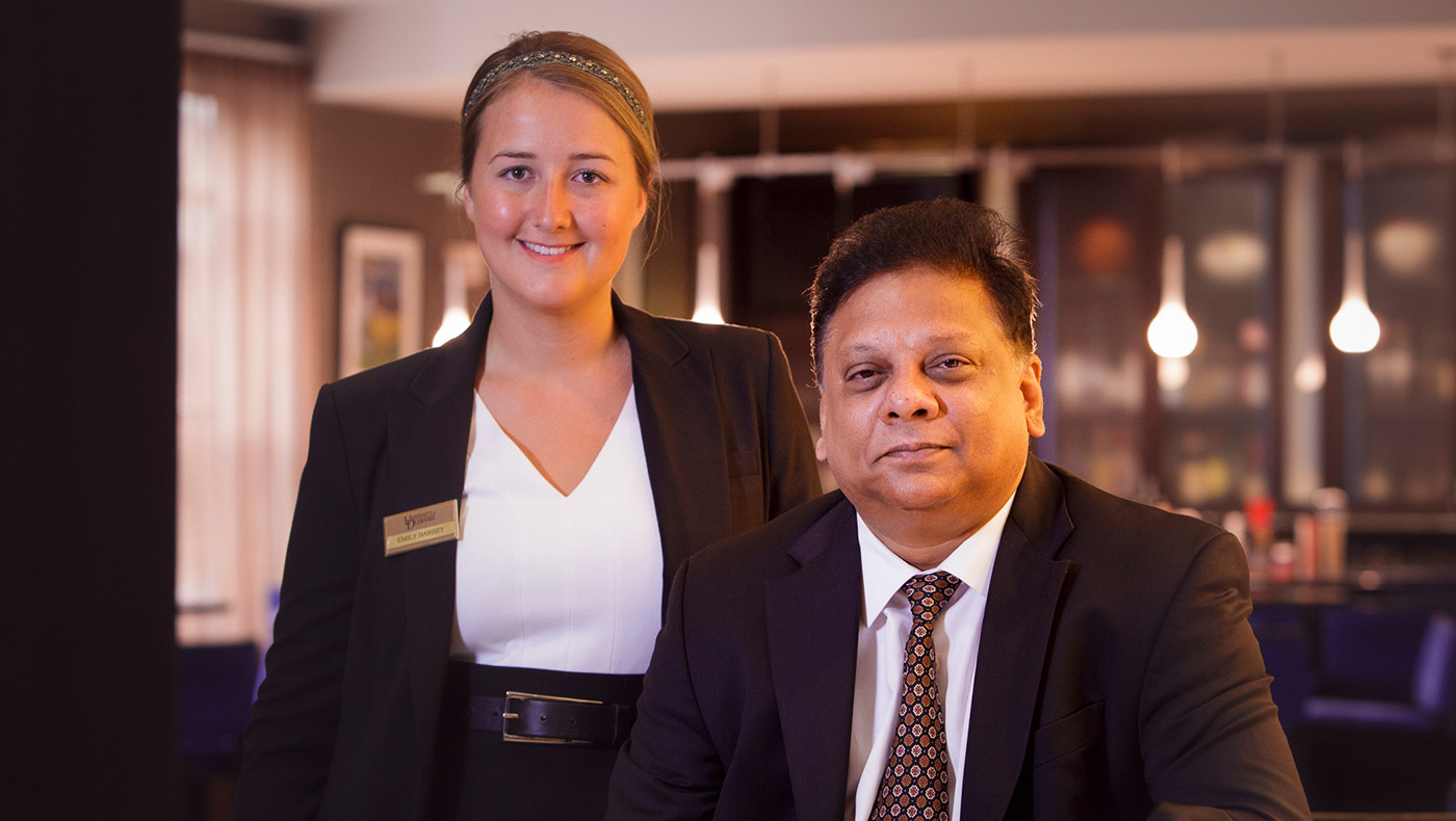 A student and professor in the Marriott Center for Tourism & Hospitality.