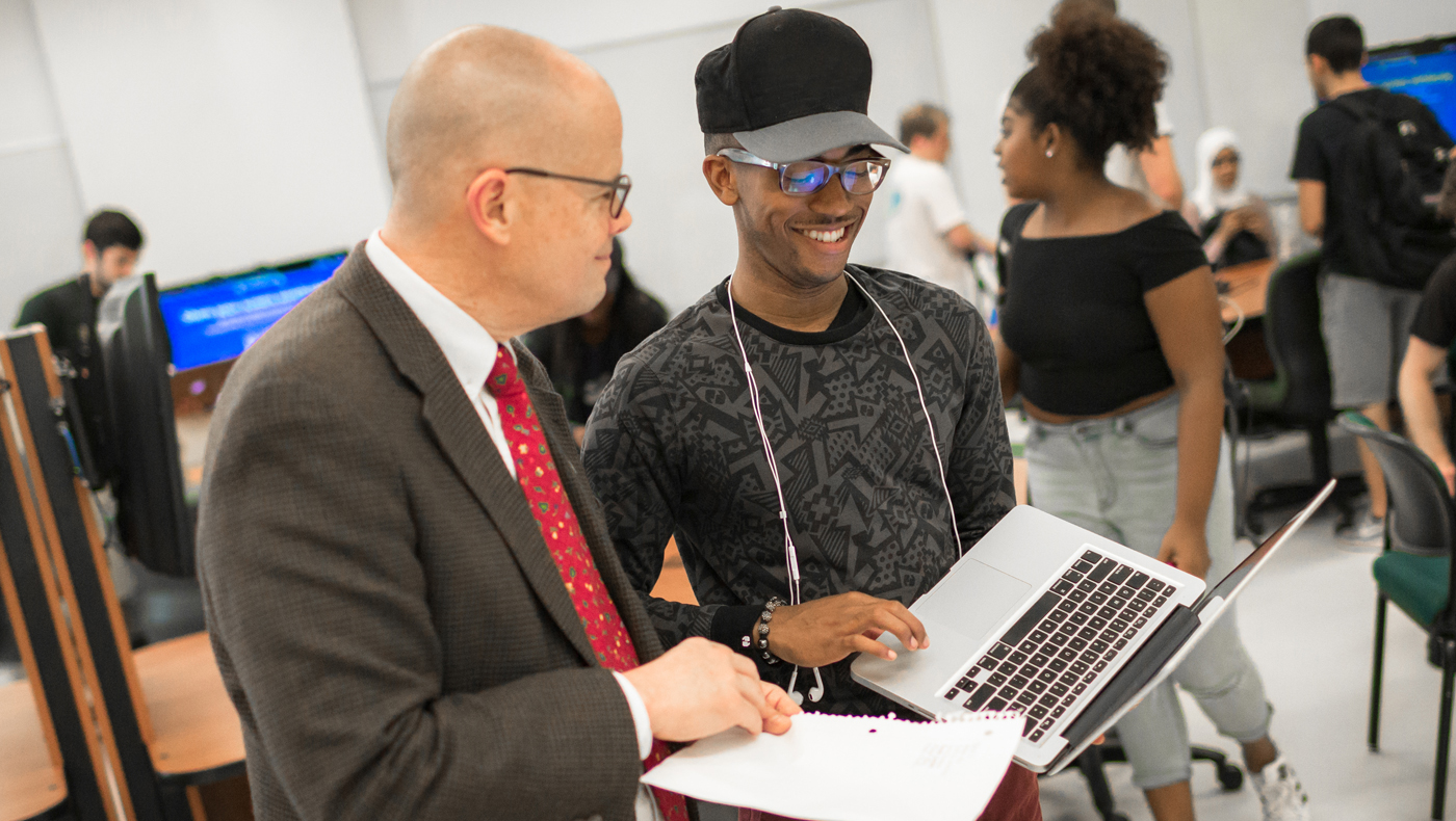 An MIS student speaking with a professor.