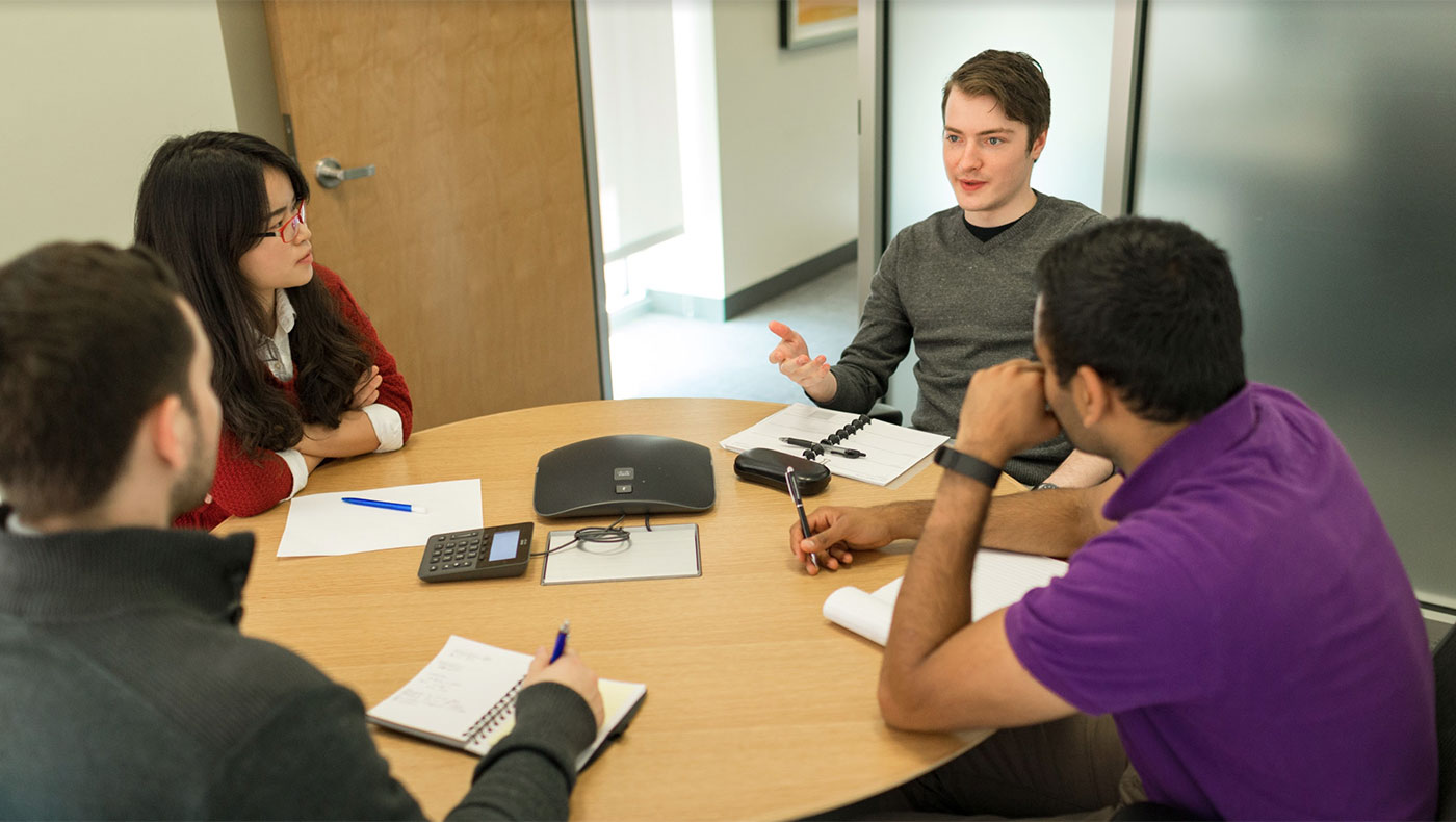 Students at a conference table.