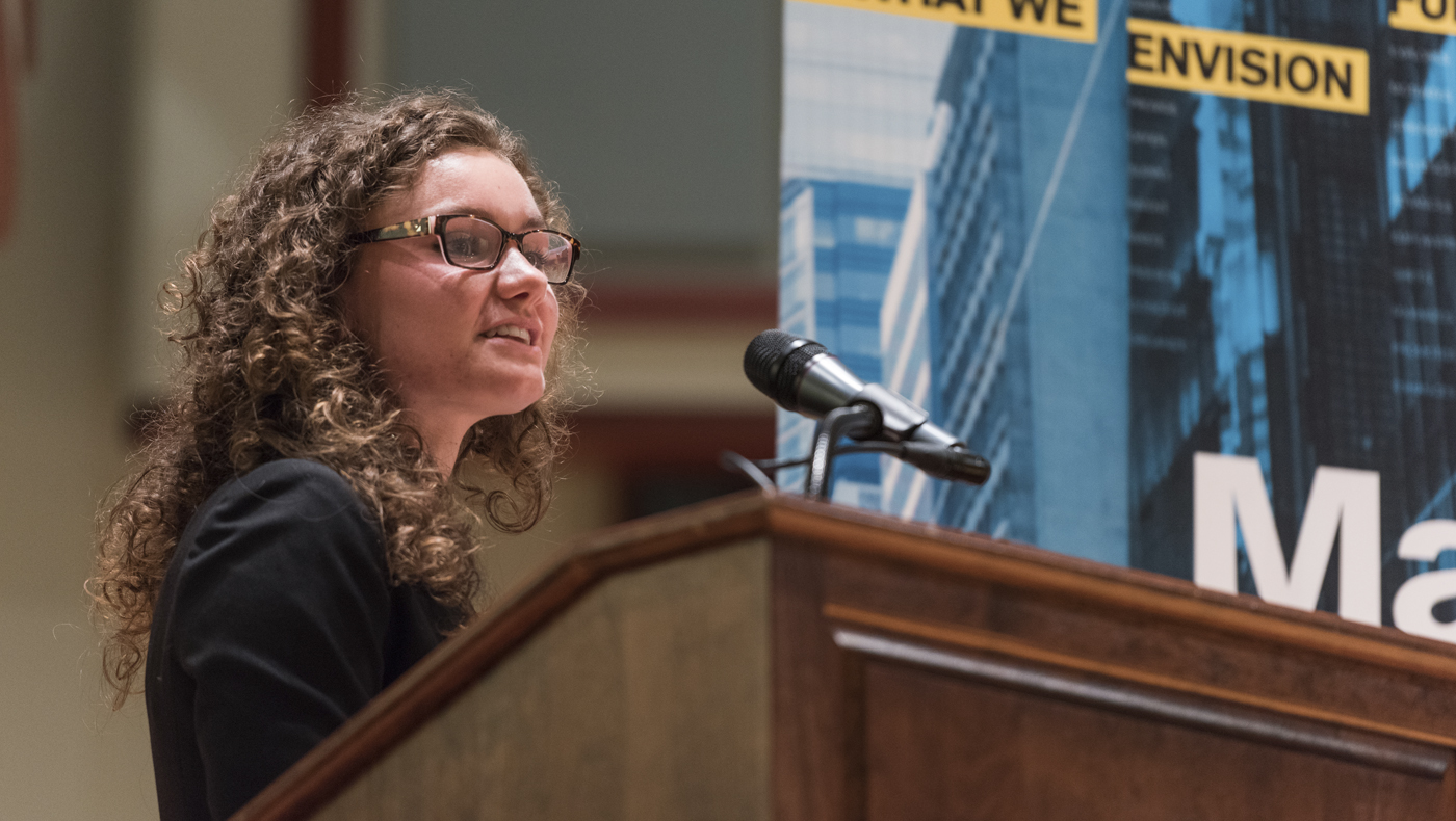 A Lerner student speaking at a podium.