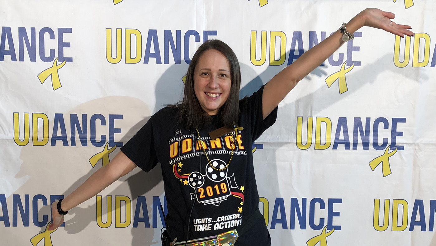 Allison Worms poses for a photo in front of a UDance background