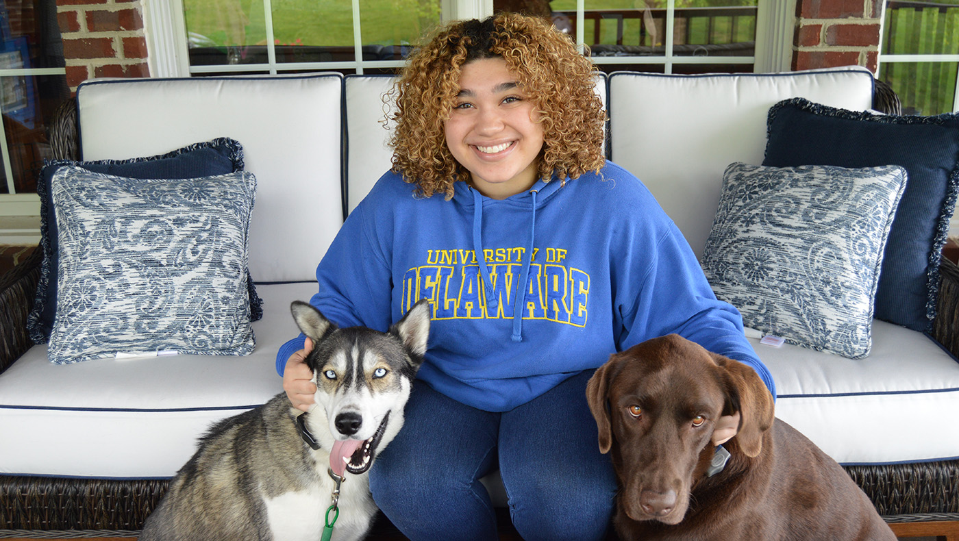 Caitlyn Fernandes poses with her dogs