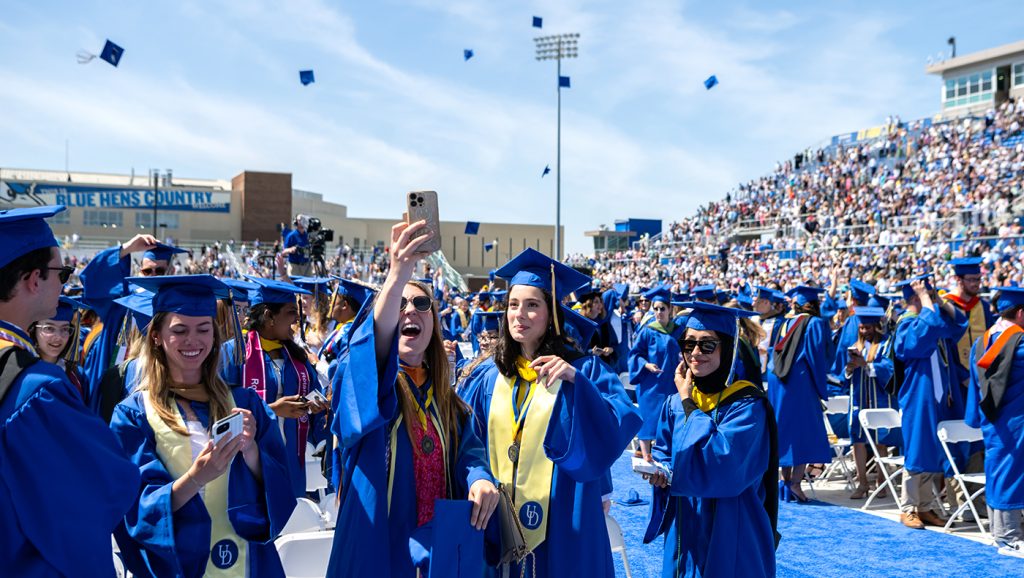 Photo of UD Lerner Class of 2023 celebrating their graduation by throwing their caps.