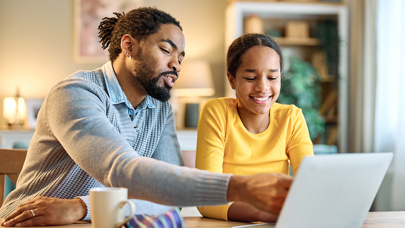 Father and daugher working on a computer