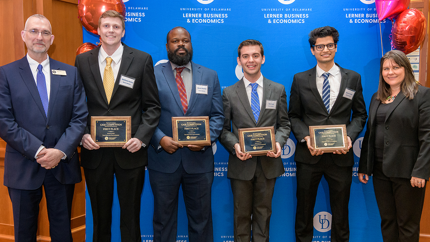 Matthew Gentry, Alex Huey, David Mahon and Apruva Shukla smile after the announcement that their team, the Buzzer Beaters, had won the 2019 Carol A. Ammon Case Competition.