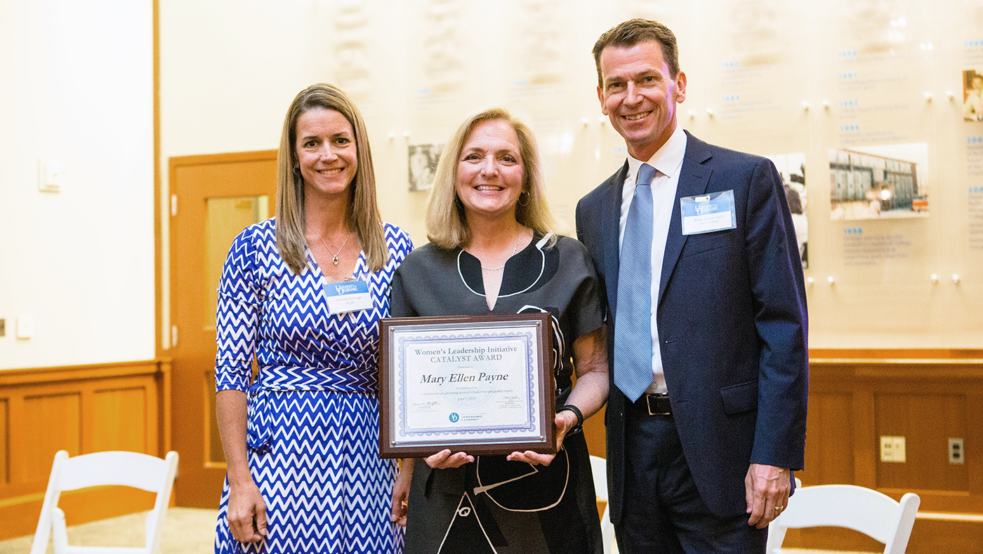 Amanda Bullough (left) and Bruce Weber (right) present Mary Ellen Payne with the inaugural Lerner Women’s Leadership Initiative Catalyst Award.