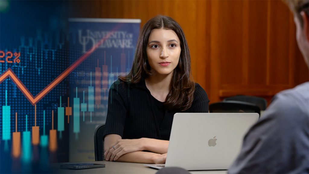 Antonia Vazquez sitting at a desk with her laptop.