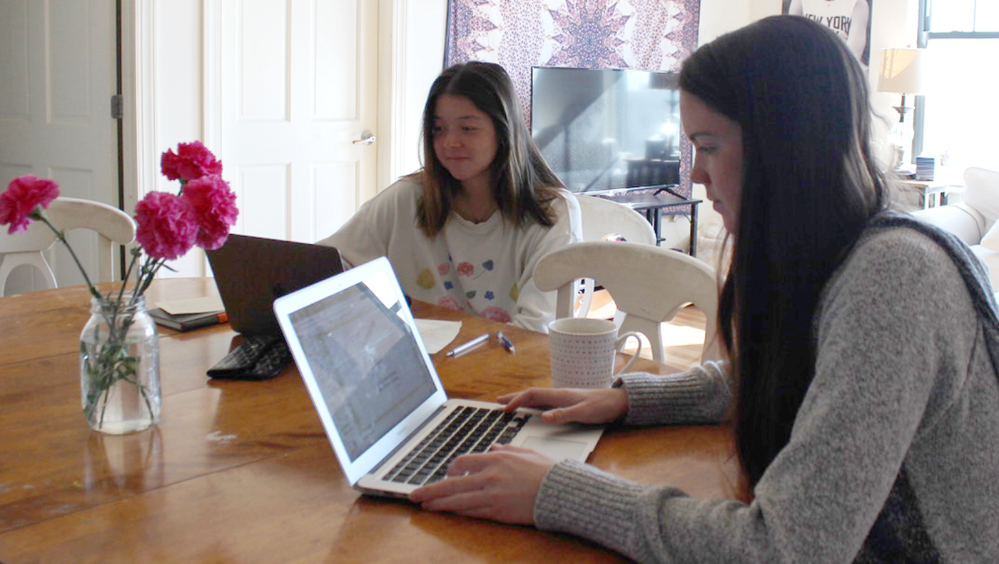 Students work from home on a project.